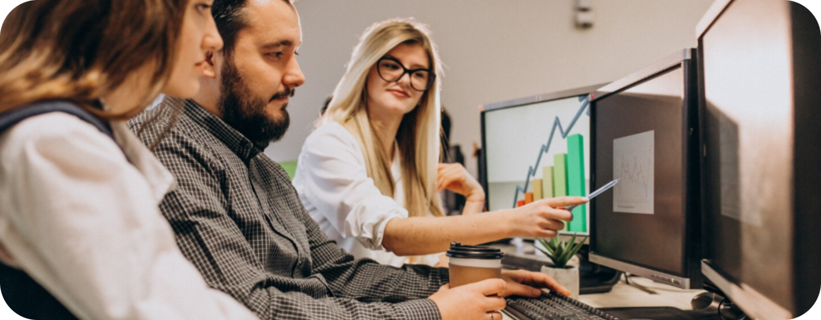 Team reviewing analytics on dual monitors